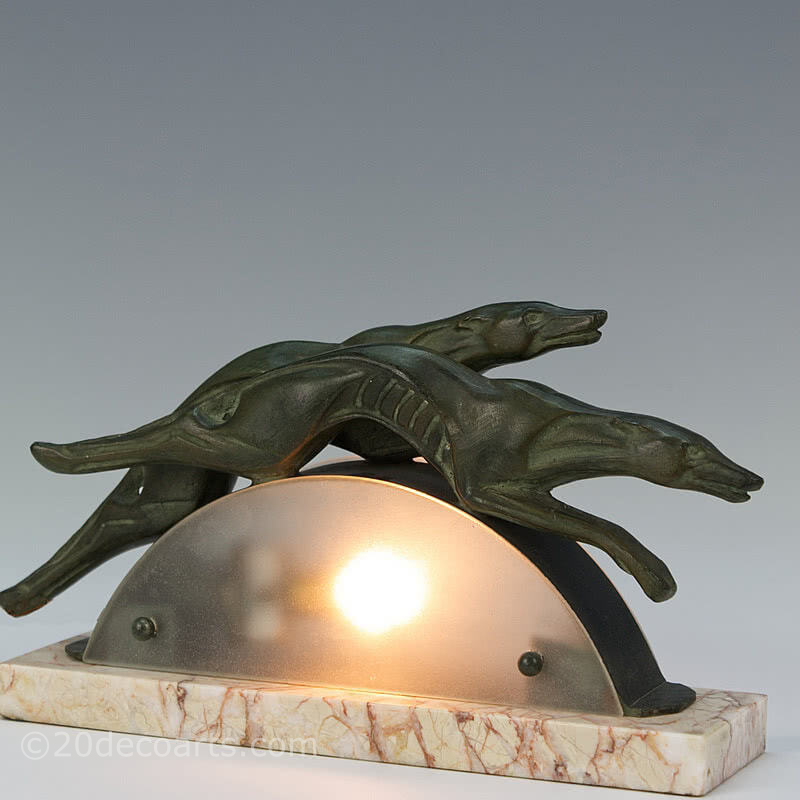  20th Century Decorative Arts |A very stylish art deco spelter lamp, circa 1930s, France - the bronze patinated stylised metal greyhounds leaping over a frosted glass arc, mounted on a marble base 