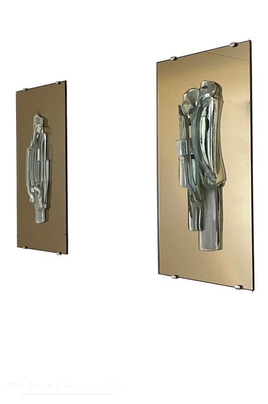   Raak, Amsterdam, A Pair Of Sculptural Glass And Mirror Wall Sconces, c1965. The unique free form glass sculpture sits on a bronze tint mirror plate 