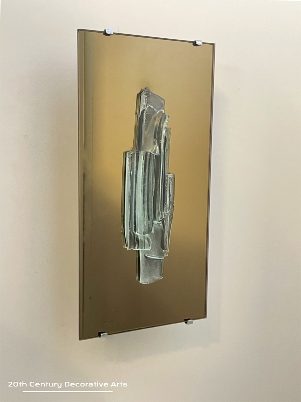  Raak, Amsterdam, A Pair Of Sculptural Glass And Mirror Wall Sconces, c1965. The unique free form glass sculpture sits on a bronze tint mirror plate