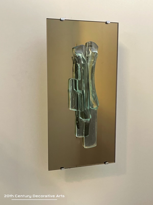  Raak, Amsterdam, A Pair Of Sculptural Glass And Mirror Wall Sconces, c1965. The unique free form glass sculpture sits on a bronze tint mirror plate 