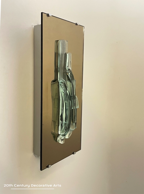  Raak, Amsterdam, A Pair Of Sculptural Glass And Mirror Wall Sconces, c1965. The unique free form glass sculpture sits on a bronze tint mirror plate 