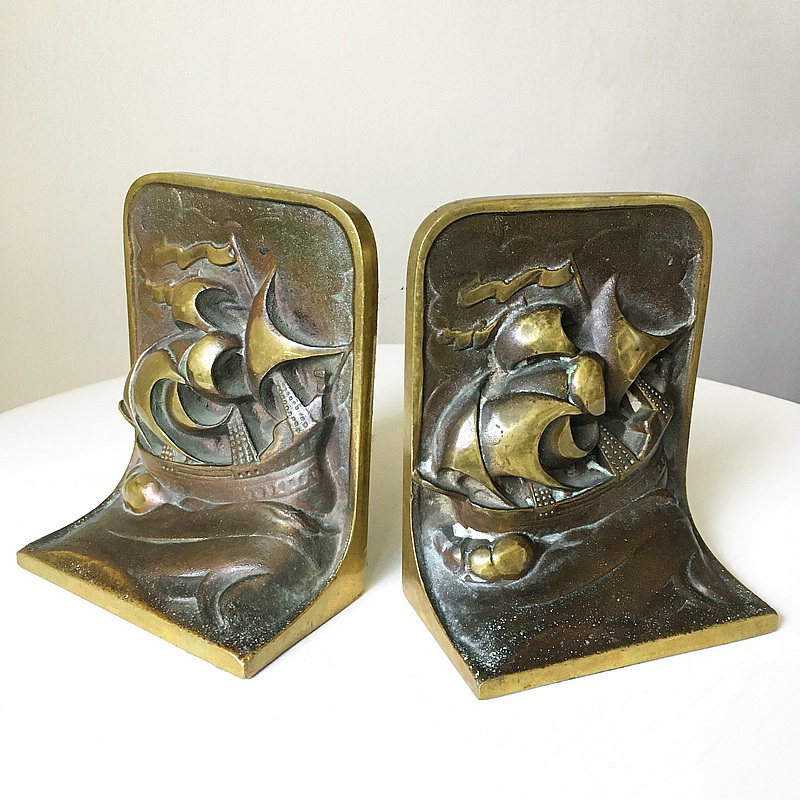  Art Deco Bronze Bookends c1930’s, the lacquered bronze patinated and polished, each featuring galleons at sea in full sail  