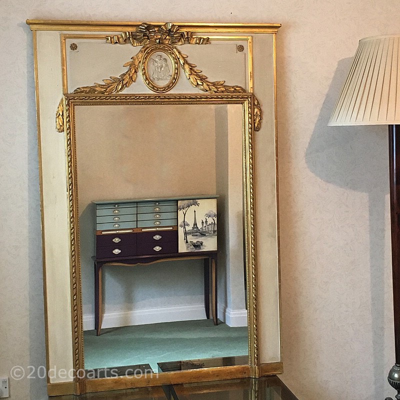   French Empire Style Trumeau Mirror, Early 20th century. The rectangular mirror set in a painted wood and parcel gilded plaster frame