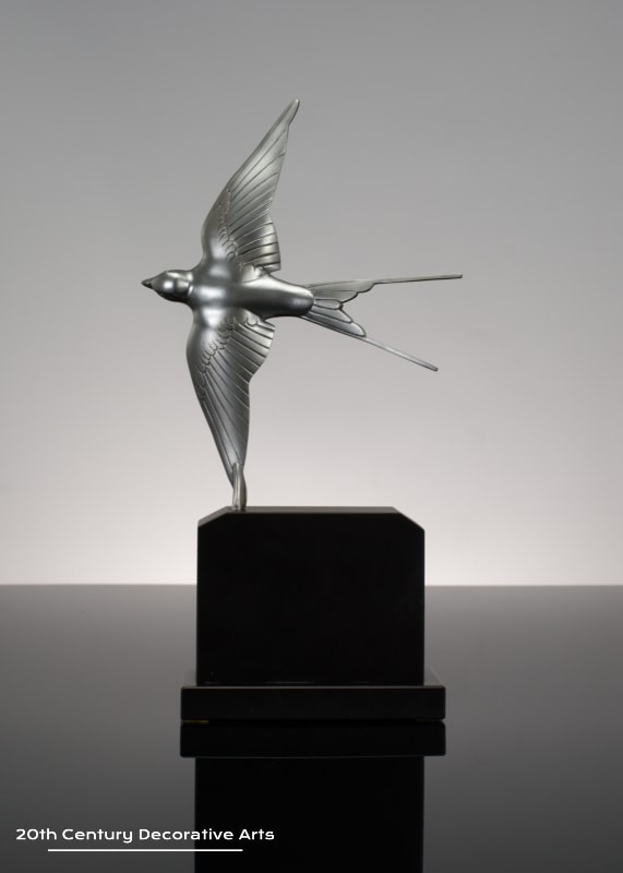  Henri Rischmann - An Art Deco silvered bronze sculpture Hirondelle, France circa 1925, the bronze swallow in flight mounted on a black marble base.