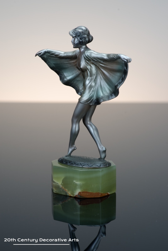  Otto Scheer - An Art Deco bronze figure circa 1930 - depicting a costumed young woman cold-painted silver