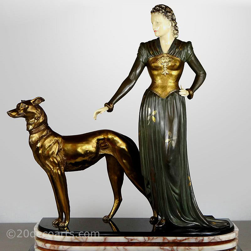  20th Century Decorative Arts |A large Art Deco font d'art (spelter) and ivorine figure by Menneville, France c1930s, " Retour du Bois", the elegant lady with her faithful hound (designed by Rochard) on an elaborate marble base 