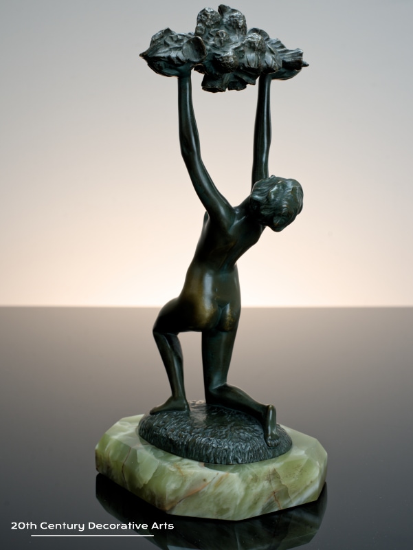   Art Deco bronze sculpture for sale circa 1930 the nude dancer holding aloft an abundance of flowers.