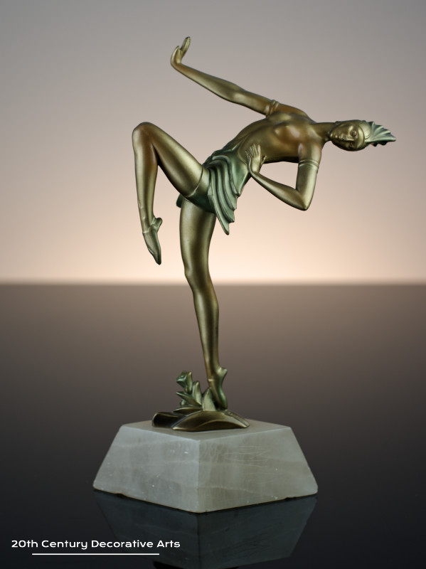  Art Deco German spelter figure circa 1930, the female dancer in futuristic ballet costume, cold-painted gold and enamelled, mounted on a shaped alabaster base