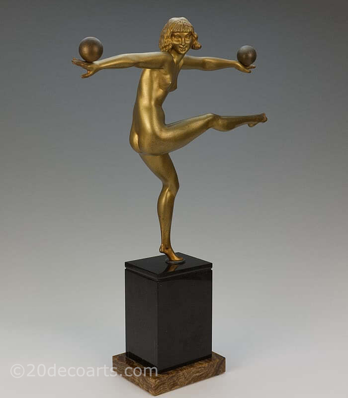  20th Century Decorative Arts |A stunning Art Deco French bronze figure by Marcel-Andre Bouraine, circa 1925, " Jongleuse". depicting a stylish dancer, with a gold painted finish, mounted on a black and brown marble plinth