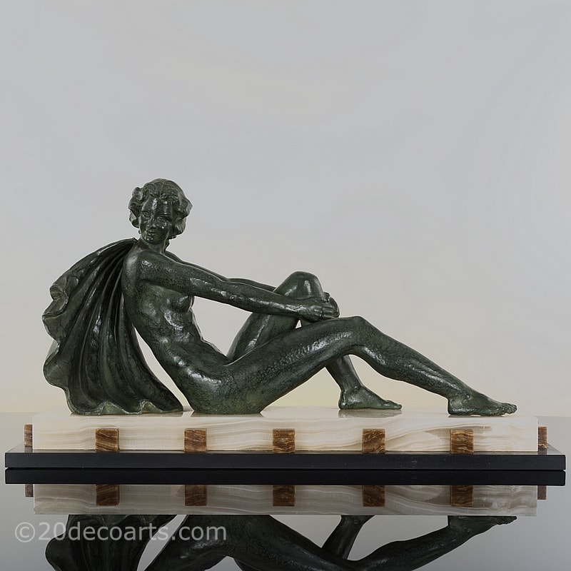  Art Deco spelter figure by Ugo Cipriani, the antiqued green finish stylish figure on a dramatic marble and onyx base 