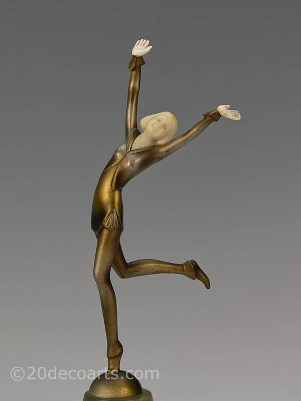  Stefan Dakon bronze and ivory figure  circa 1930 depicting a stylishly attired young lady with carved ivory head and hands, and a silvered and enamelled cold-painted finish, mounted on a shaped onyx base