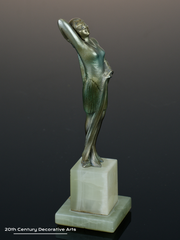  20th Century Decorative Arts | An exquisite Art Deco Austrian bronze figure by Josef Lorenzl, circa 1930 "Fashion" depicting a stylish modern woman, with a silver, gold and enamelled cold-painted finish, mounted on a green onyx base