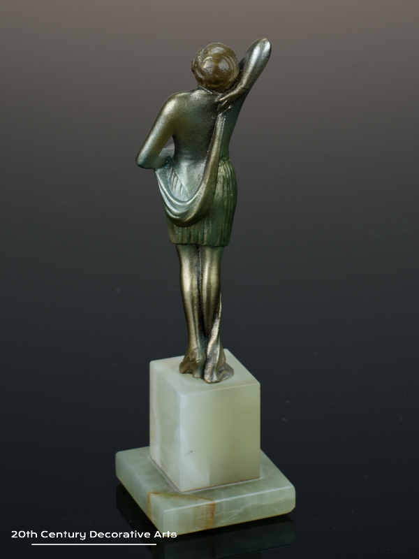  20th Century Decorative Arts |An exquisite Art Deco Austrian bronze figure by Josef Lorenzl, circa 1930 "Fashion" depicting a stylish modern woman, with a silver, gold and enamelled cold-painted finish, mounted on a green onyx base
