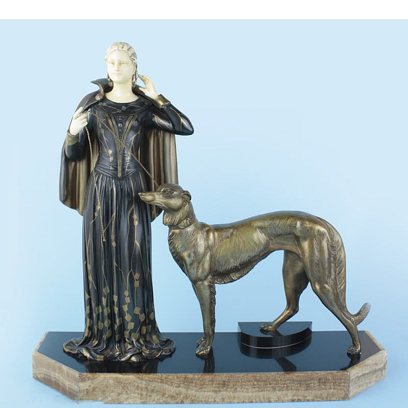  20th Century Decorative Arts |A large Art Deco spelter "chryselephantine" figurine by Menneville et Rochard, the elegant female with ivorine head and hands wearing an opera cape accompanied by her faithful Borzoi hound 